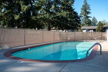 a resort style pool with a fence around it